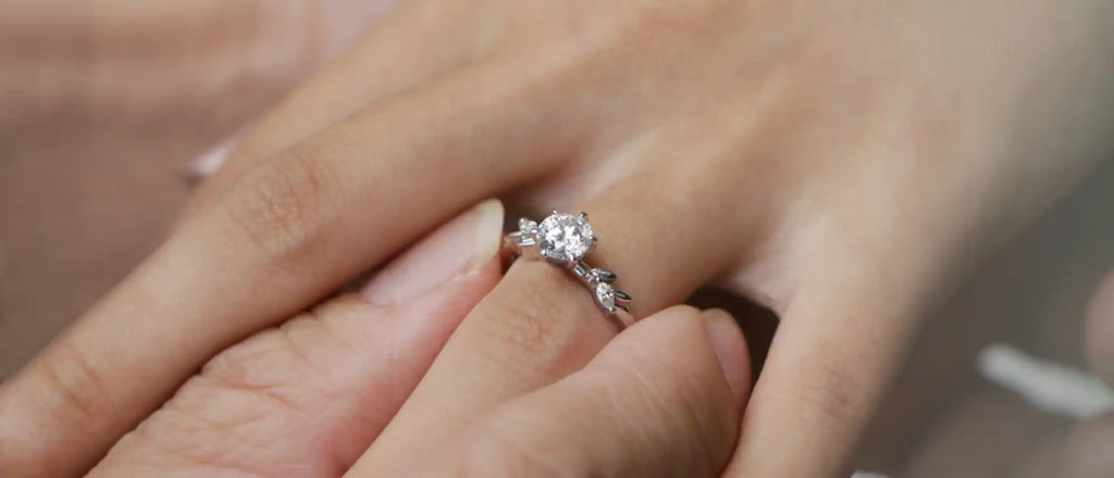 Diamond engagement ring with a delicate silver or white gold band.